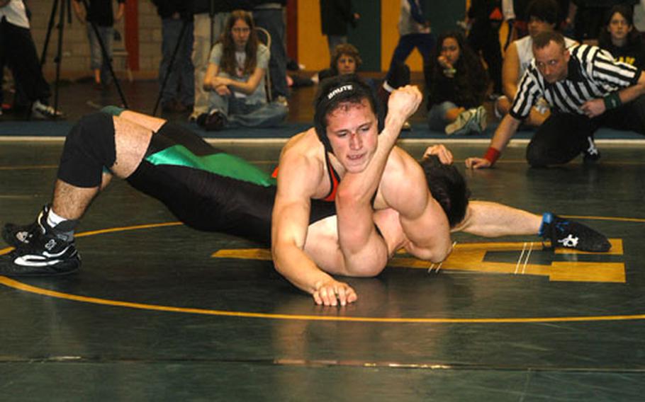 Menwith Hill's Jesse Best (top) gets a better grip on SHAPE's Roberto Busquier in the 145-pound weight class championship during the Northern Sectionals Wrestling tournament Saturday at RAF Alconbury. Best won by pinning Busquier in 3 minutes and 24 seconds.