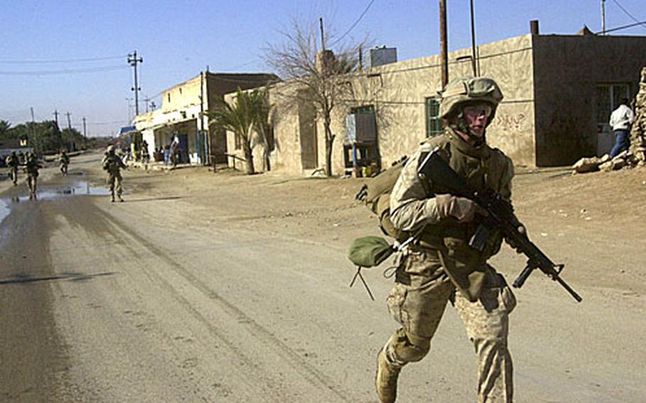 Marines with Company G, 2nd Battalion, 3rd Marine Regiment patrol Monday through Bani Dahir, Iraq, which is just south of Haditha in Anbar province. Marines continually patrol the city to maintain visibility in the area.