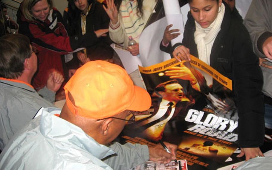 Madelina Brown, right, on Thursday gets a leaflet autographed by Harry Flournoy of the Texas Western 1966 NCAA basketball championship team after a showing of the movie "Glory Road" at Patch Theater in Stuttgart, Germany.