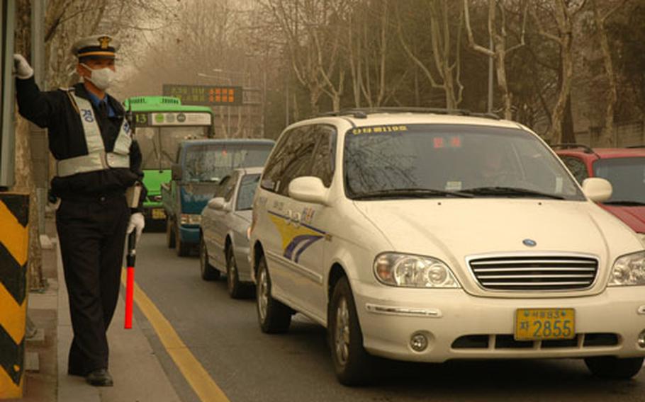When the dust gets this bad, many public workers, including traffic and riot police, wear masks to avoid inhaling the fine sand.