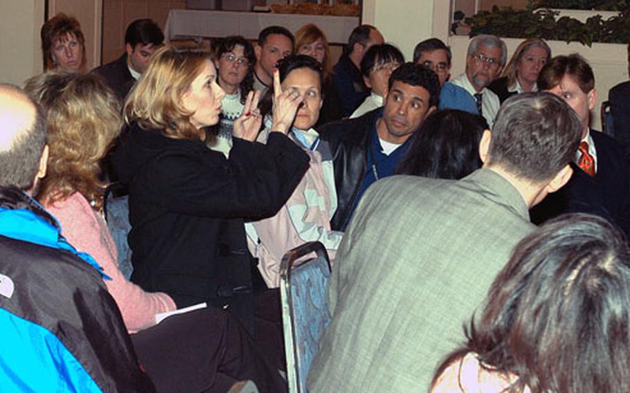 Members of the U.S. Embassy community in Seoul question DODDS personnel about problems with bullying in the schools during a Thursday night meeting.
