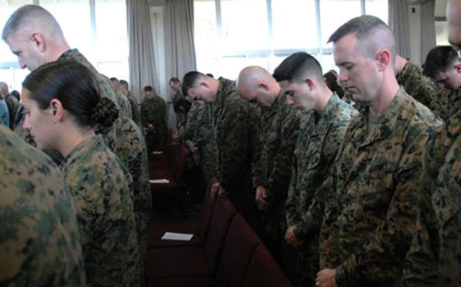 Marines listen to prayers during the memorial service Friday for Cpl. Thomas Saba, who was killed in Iraq last week.