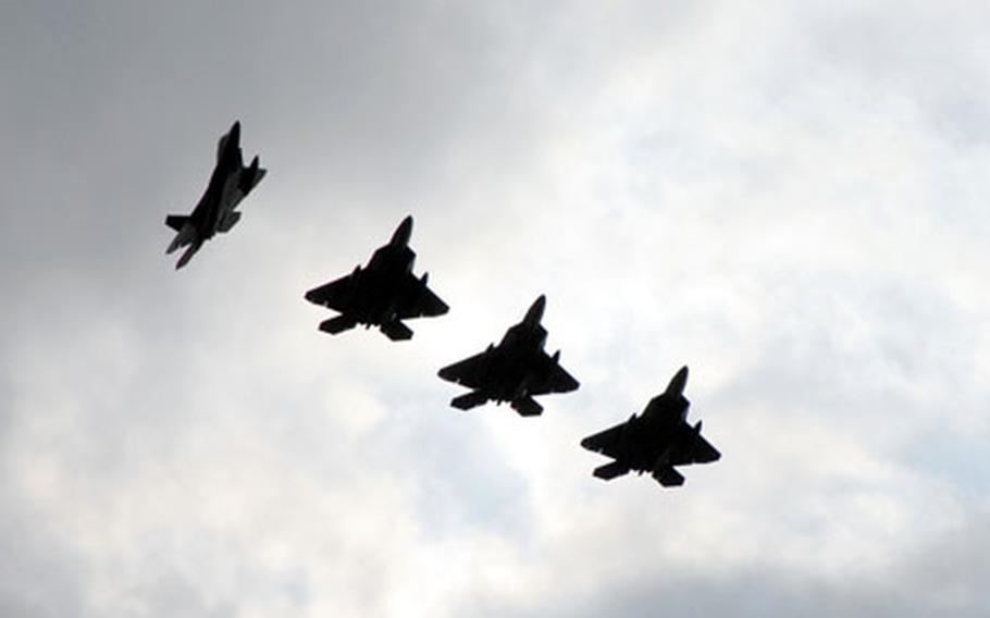 F-22 Raptors fly into Kadena Air Force Base on Saturday afternoon. The 27th Fighter Squadron is at the base from Langley Air Force Base, Va. for several months of training in the Pacific.