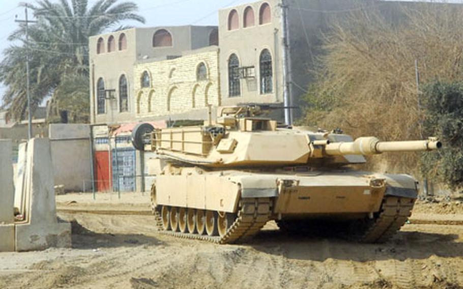 An Abrams tank with the 3rd Battalion, 69th Armor Regiment, 1st Brigade Combat Team, 3rd Infantry Division, watches over a street corner in downtown Ramadi recently.