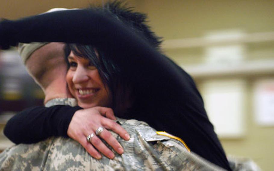 Sgt. Gregory Dinsmore, of the 1st Battalion, 36th Infantry Regiment, gets a big hug from his wife, Teresa, at his homecoming early Wednesday morning. Dinsmore spent nearly 14 months in Iraq, mostly in Ramadi.
