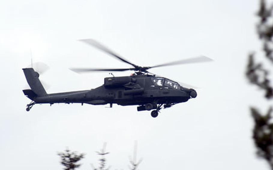 A 2nd Battalion, 159th Aviation Regiment, 12th Combat Aviation Brigade Apache attack helicopter flies over Grafenwohr during a running rocket and missile shoot on Friday.