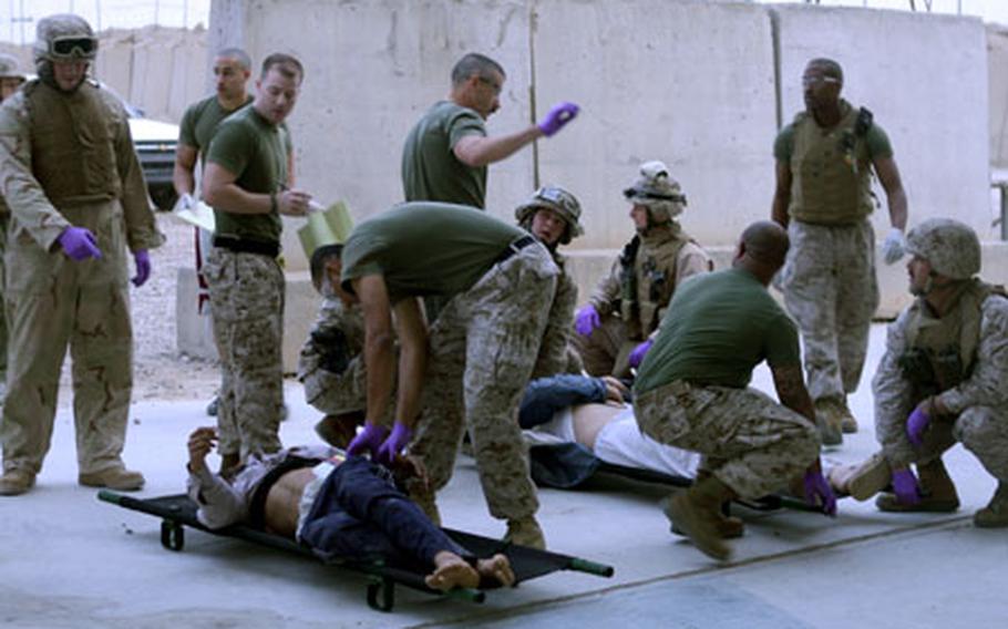 Servicemembers assist victims of a Feb. 24 suicide truck bomb blast. Fifty Iraqis were treated at Taqaddum’s surgical detachment.