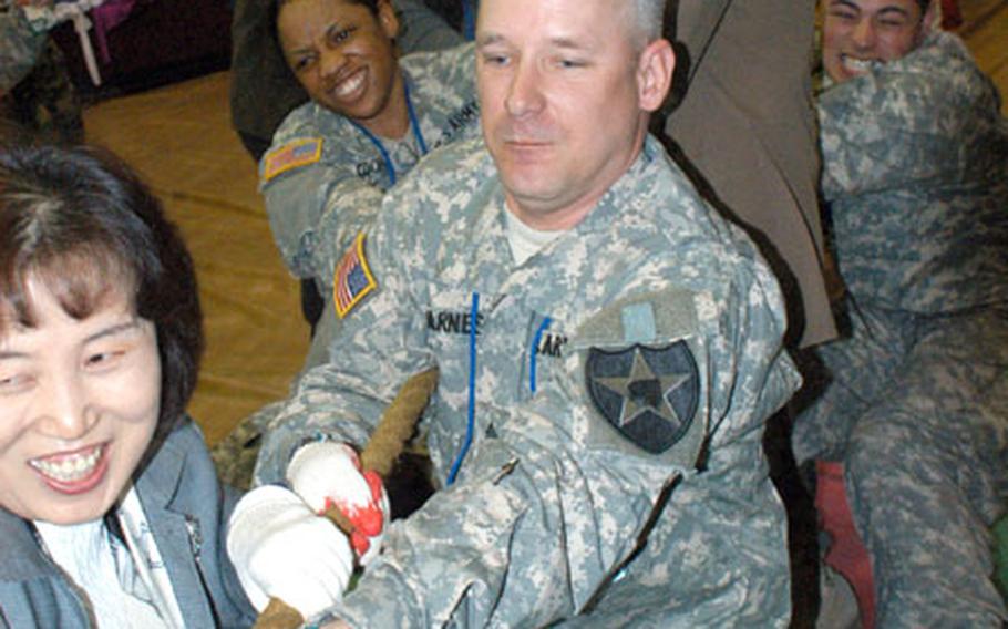 Soldiers from the 2nd Infantry Division celebrate their new “sisterhood” with the Gyeonggi community following a signing ceremony at the Camp Red Cloud Gym on Wednesday.