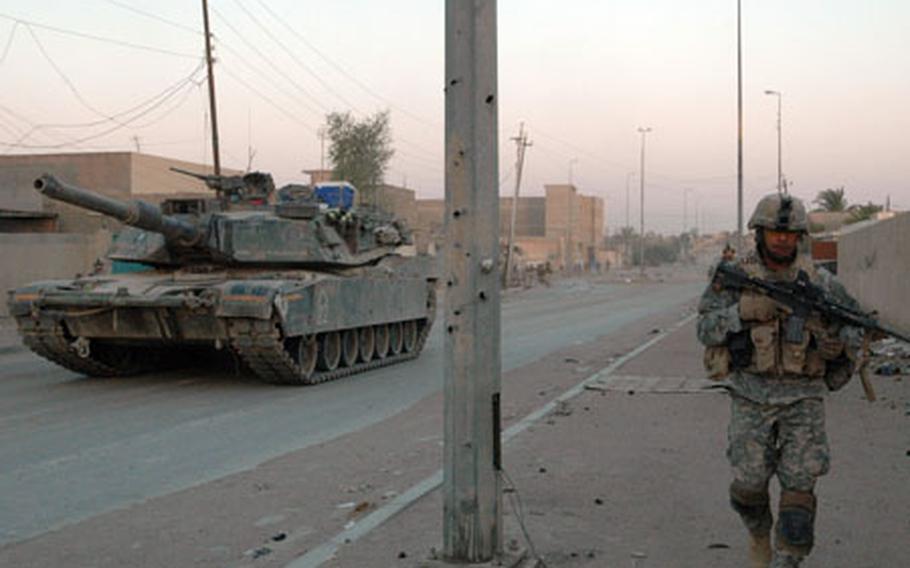 Soldiers and tanks from Company B, 1st Battalion, 37th Armor Regiment leave Combat Outpost Falcon on a recent operation in downtown Ramadi.