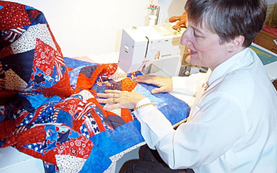 Kathy Hansen uses a sewing machine to make a quilt at her home in embassy housing at Yongsan Garrison. Eventually the quilt will be sent to a soldier who has been wounded in the global war on terror.