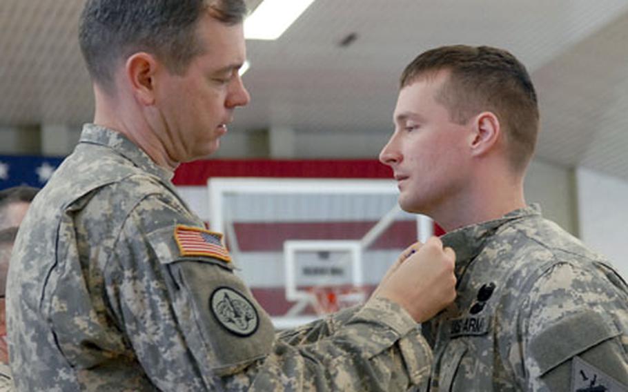 Col. Sean MacFarland, commander of 1st Brigade, 1st Armored Division pins the Soldier's Medal on Sgt. Christopher Cafaro, at a ceremony in Friedberg, Germany, on Monday. Cafaro was awarded the Army's highest peacetime honor for saving lives during a fire at the Joint Maneuver Training Center in Hohenfels, Germany in October, 2005. Cafaro and MacFarland recently returned to Friedberg from a 14-month deploymet to Iraq.