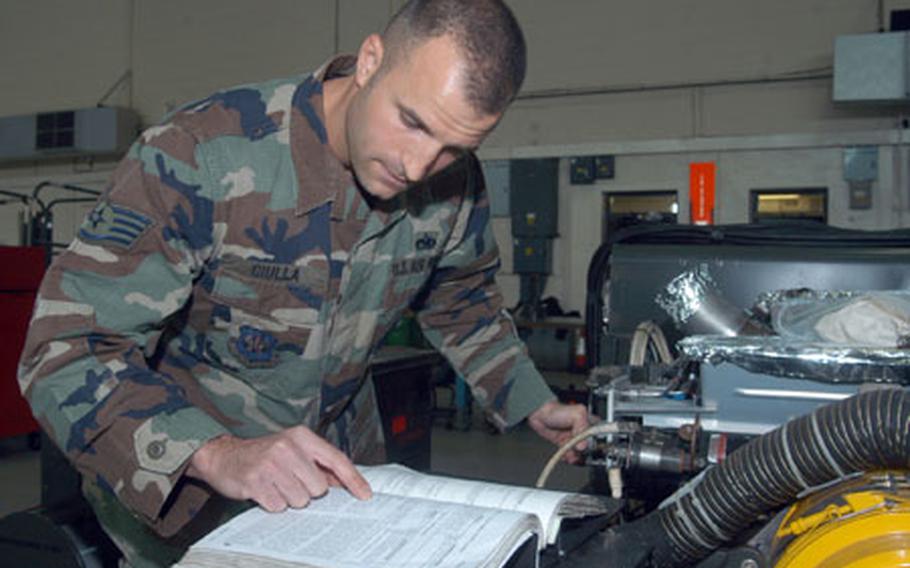 Staff Sgt. Joseph Ciulla, from the 100th Maintenance Squadron, refers to a manual as he inspects a gas turbine compressor. The Cleveland native said he was heading down the wrong path as a youth, so he joined the Air Force. Nine years later, he became Mildenhall's NCO of the Year.
