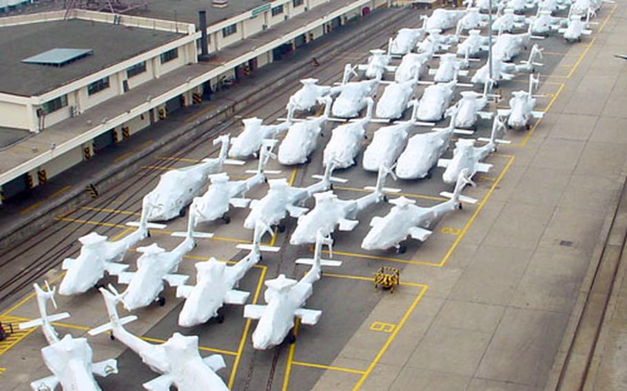 Pierside at the Army's Pier 8 in Busan, South Korea in this September 2002 photo, shrink-wrapped AH-64 Apache helicopters await loading onto ship bound for the United States. The Army's 837th Transportation Battalion (Terminal), now headquartered in Daegu, oversees all the U.S. military's seagoing shipments into and out of South Korea.