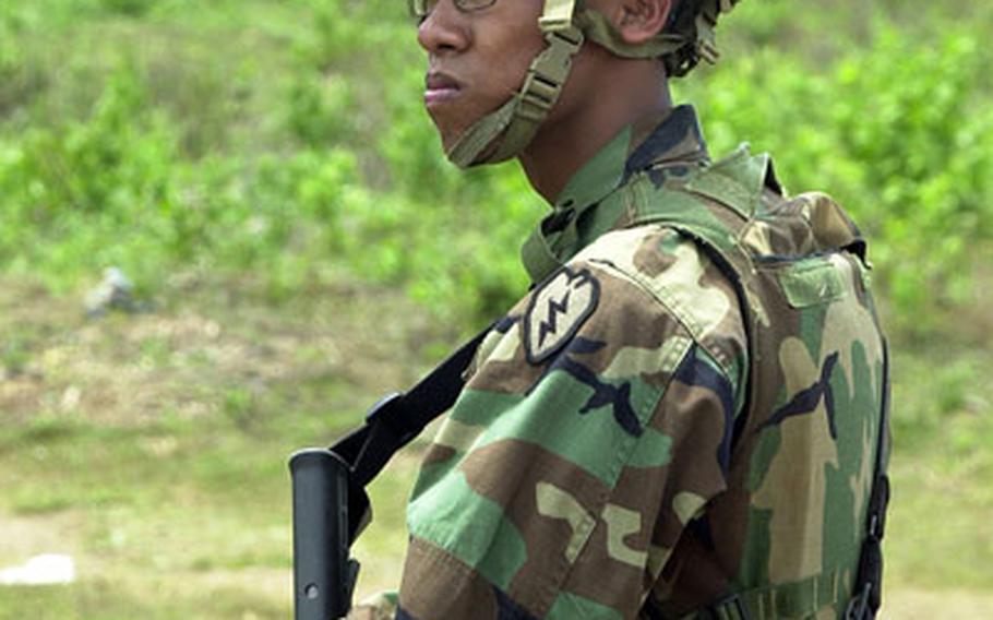 U.S. Army Pfc. Mark Retotal, with the Hawaii-based 1st Battalion, 21st Brigade, 25th Infantry Division, stands guard duty on an airstrip on Jolo Island, Philippines.
