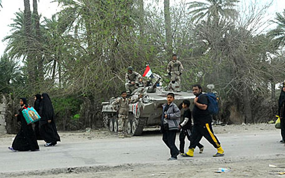 Iraqi soldiers with the 4th Brigade, 6th Iraqi Army Division watch over the Arba'een pilgrimage recently in Mahmudiyah from their Russian-made BMP armored personnel carrier.