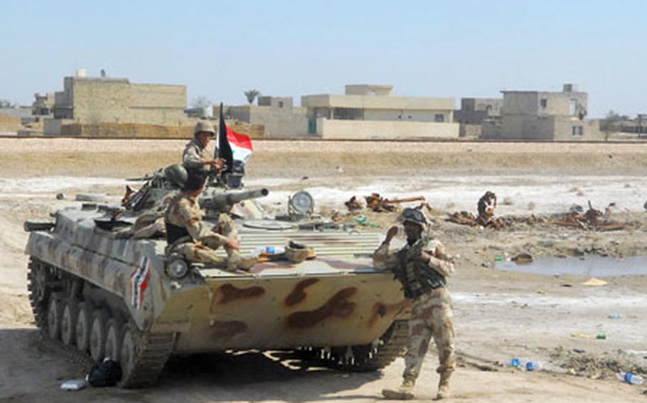 Soldiers with the 4th Brigade, 6th Iraqi Army Division watch over the Arba'een pilgrimage recently in Mahmudiyah from their Russian-made BMP armored personnel carrier.