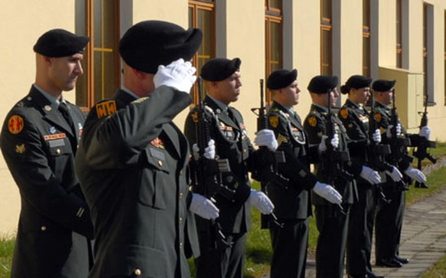 An honor guard stands at present arms after firing a 21-gun salute during a memorial ceremony for three fallen military policemen at the Bamberg, Germany, community chapel Tuesday. The MPs, Sgt. Brandon A. Parr, Sgt. Michael C. Peek and Sgt. Ashly L. Moyer, were from the 630th MP Company.