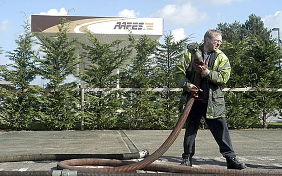 Cliff Kingham, from the Bob Terry Haulage Company, takes a hose back to his truck after pumping 32,500 liters of fuel from a storage tank at RAF Mildenhall's gas station last Thursday after tests showed that the fuel was contaminated.