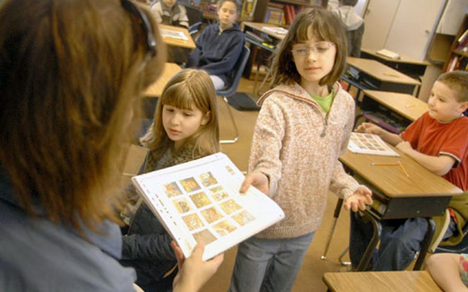 Rachel Nipper, a fifth-grader at Landstuhl Elementary and Middle School, receives her copy of the Terra Nova test Wednesday from Jennifer Henry, Nipper’s home room teacher. Rachel is taking the science portion of the standardized test that also evaluates math, reading, writing and social studies during the four-day testing period.