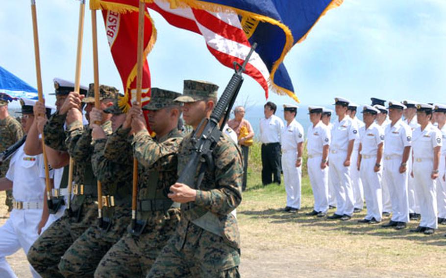 Marines present the colors at the ceremony Wednesday, along with two Japanese sailors who were taught the moves the day before. One of the Japanese sailors said he didn't really want to participate until he realized how precious the color guard is to the Marines.