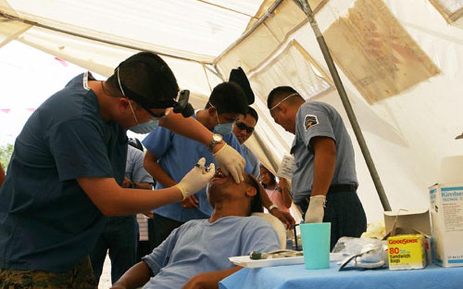 U.S. Navy Lt. David Liu gives a patient a shot to numb his mouth before performing a dental procedure. U.S. Marines and sailors from the 3rd Marine Expeditionary Brigade along with sailors from the USS Comstock are in the Philippines as part three of this year's Operation Goodwill.