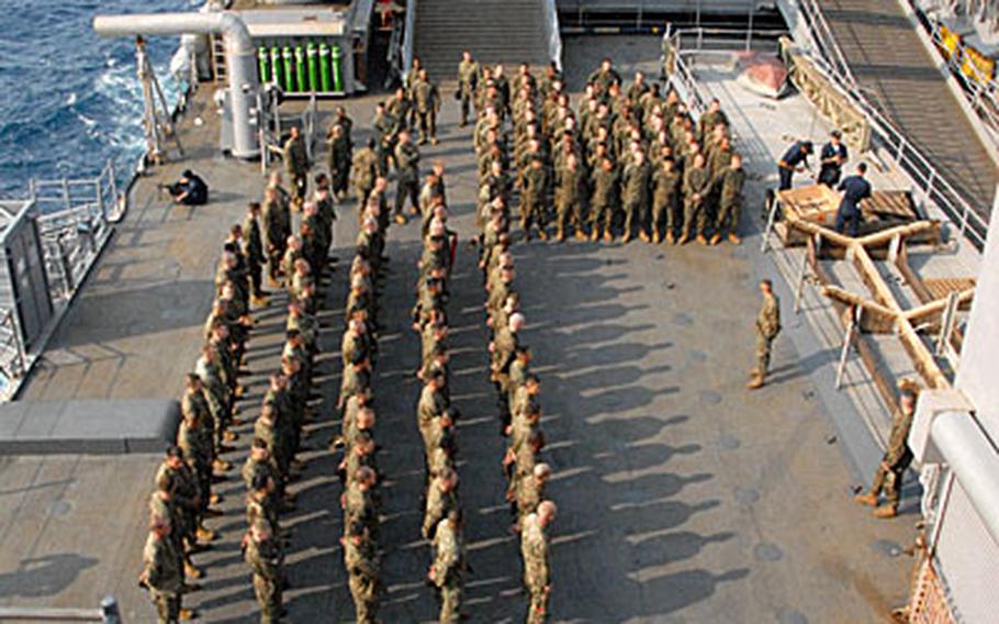 Marines with Marine Wing Support Squadron 172 stand in formation on USS Harpers Ferry on March 10, their first day onboard for a mission last week. The unit's sergeant major and commanding officer gave the Marines a talk about the upcoming mission and how to behave on the ship.