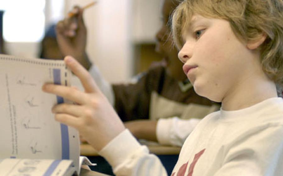 Nicholas Elden, a fifth-grader at Landstuhl (Germany) Elementary and Middle School, looks through his copy of the TerraNova test last week. Teachers, parents and pupils graded Defense Department schools higher than public schools on the most recent customer satisfaction survey released Friday.