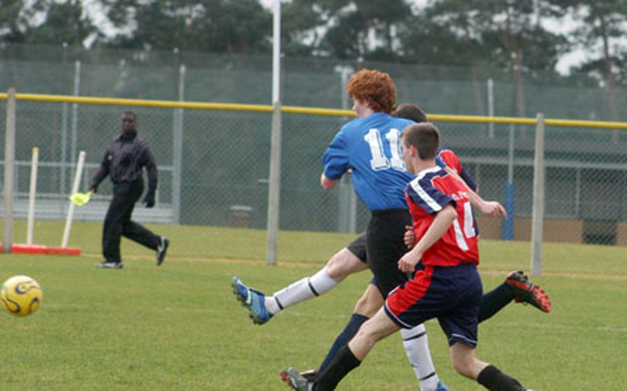 London Central junior Cameron Gill, in blue, manuvers around Menwith Hill Mustang opponents last weekend during a pre-season UK soccer jamboree at RAF Lakenheath.