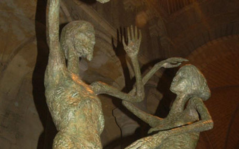 A lights beams down on a sculpture of Mary Magdalene recognizing Jesus Christ on the morning of his resurrection.