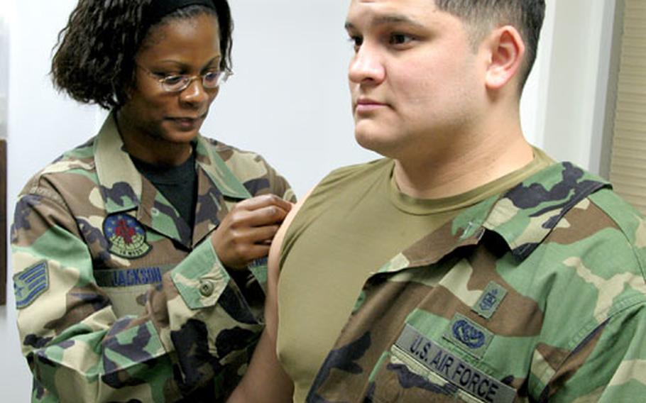 Staff Sgt. Sakinah Jackson, an allergy immunization technician with the 18th Medical Group, administers the Anthrax booster to Tech. Sgt. Raymond Garcia on March 15 at Kadena Air Base, Japan.
