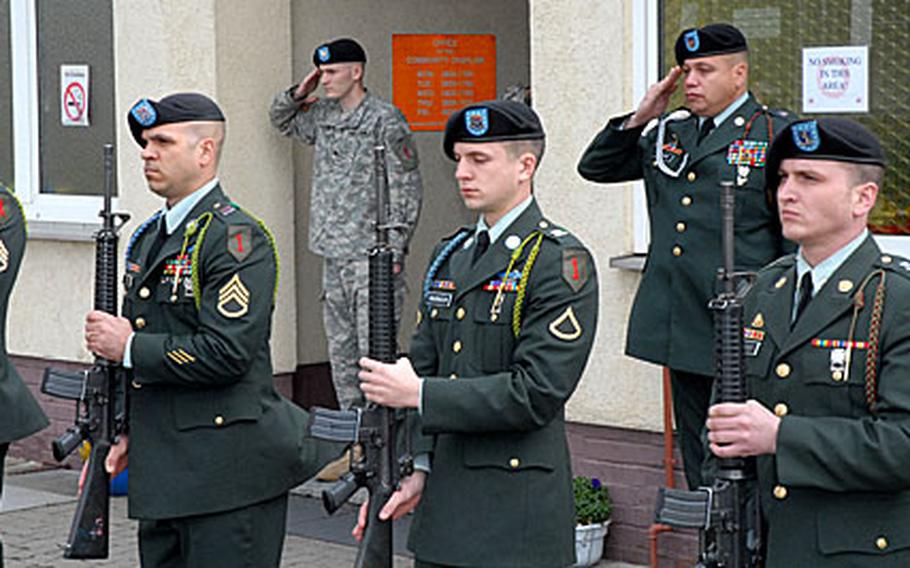 After firing a 21-gun salute, members of a 1st Infantry Division honor guard stand at present arms as taps plays during a memorial ceremony for Staff Sgt. Karl O. Soto-Pinedo at the Ledward Barracks chapel in Schweinfurt, Germany, Wednesday. Soto-Pinedo, of 1st Battalion, 18th Infantry Regiment, 2nd "Dagger" Brigade Combat Team, was killed by small-arms fire Feb. 27 in Baghdad.