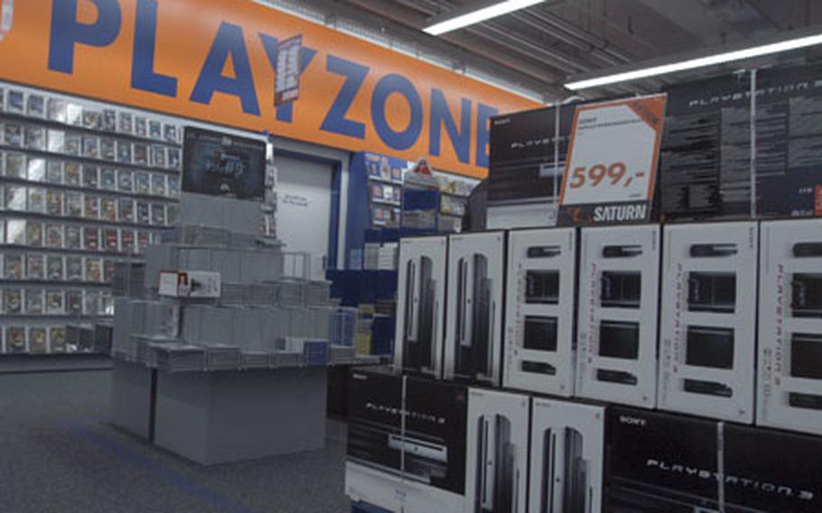 A stack of new Sony PlayStation 3 game consoles sits Friday on the sales floor of the Saturn electronics store in Darmstadt, Germany. Sony launched the PS3 on Friday in Europe. Shortages of the systems, and of Nintendo's Wii console, at Army and Air Force Exchange Service stores in Europe are attributed to supply shortages of U.S. versions of both.