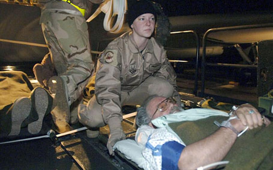Air Force Staff Sergeant Dana Sullivan prepares to load a contractor onto an aircraft during the first non-stop medical evacuation flight from Bagram Air Base, Afghanistan to Landstuhl, Germany.