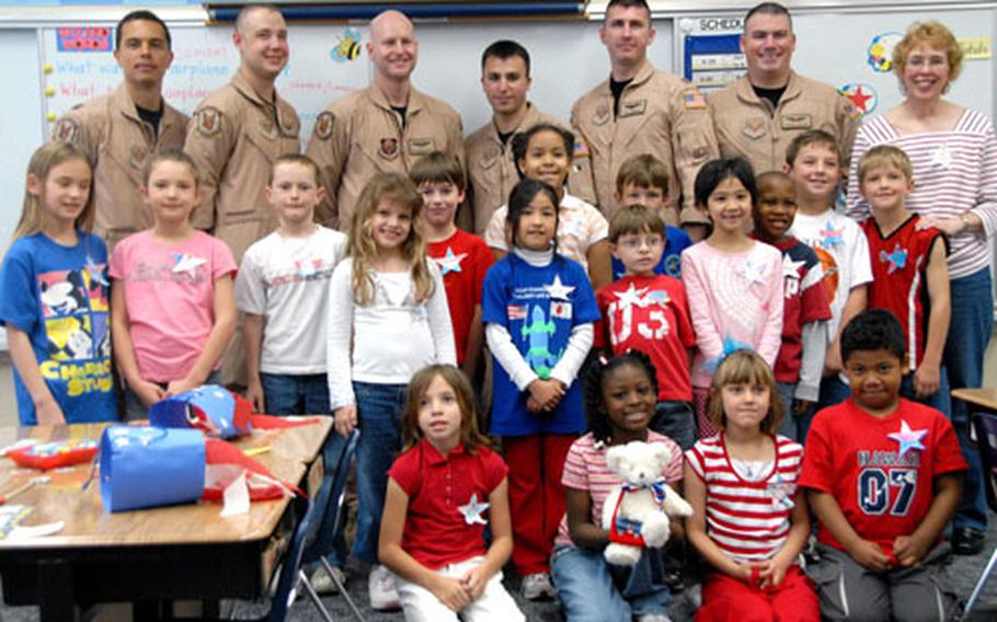 Diane LaMarr's second-grade class at E.C. Killin Elementary School on Camp Foster, Okinawa, poses for a picture Friday with the airmen they corresponded with in Iraq.