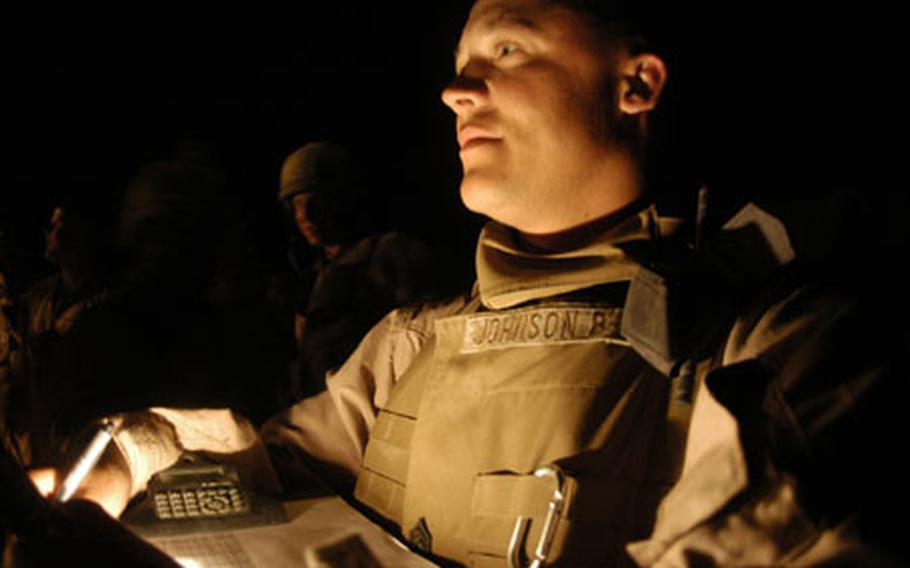 Staff Sgt. Michael Johnson, 34, the assistant convoy commander with 3rd Platoon, Transportation Support Company, Combat Logistics Battalion 2, takes a roll call late Wednesday night after his Marines returned from a re-supply mission to Haditha Dam.