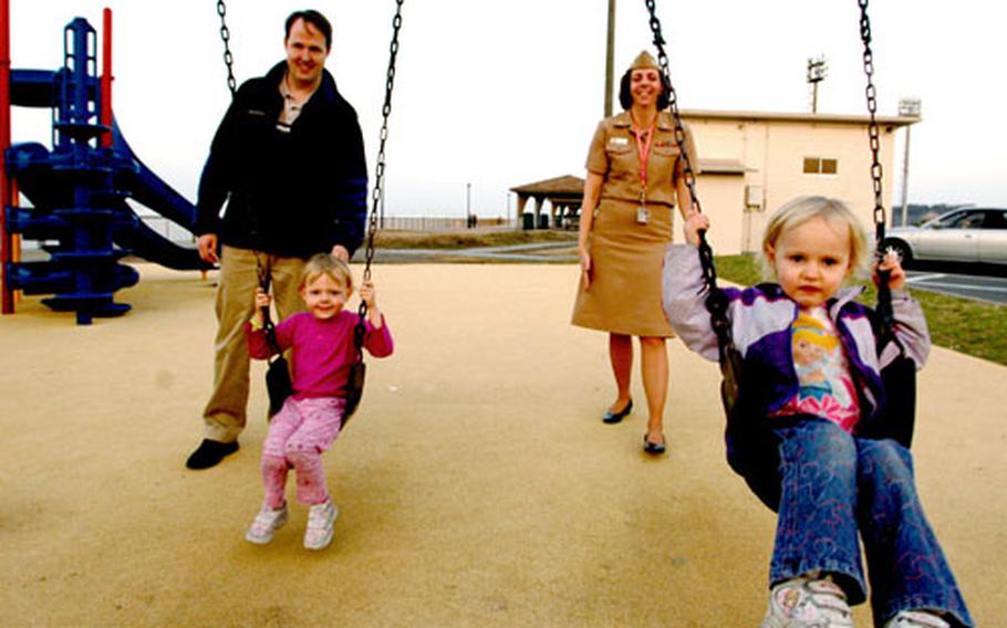 Chris Swank and his wife, Lt. Cmdr. Margaret Swank, join their daughters Rebecca, left, and Krista for a little quality time at the playground Monday at Yokosuka Naval Base, Japan. Age-appropriate family recreation provides both exercise and fun for families, officials say — exactly the aim of Navy Family Health and Wellness Week, April 7-13.