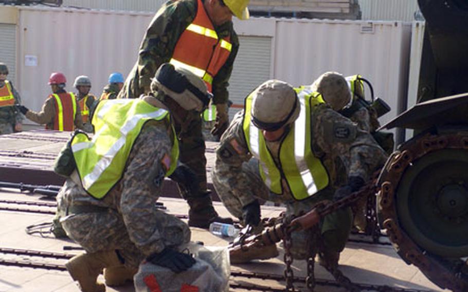 Earlier this week at Camp Carroll, South Korea, soldiers with Task Force Black Horse ready combat vehicles for transport to a training range where they were to use them in a live-fire exercise. The Task Force consists of soldiers from the 2nd Squadron, 11th Cavalry Regiment at Fort Irwin, Calif., and Battery B, 2nd Battalion, 5th Field Artillery, at Fort Sill, Okla. They were in South Korea taking part in the annual Reception, Staging, Onward Movement and Integration exercise.