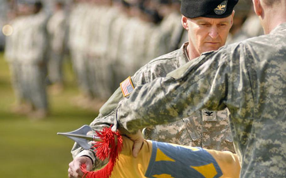 Col. Jarrold Reeves, the commander of the 200th Theater Distribution Brigade, cases the unit’s colors with Command Sgt. Maj. Keith Baughman during a deactivation ceremony Thursday at Panzer Kaserne. Along with the 200th TDB, the 37th Transportation Command and the 1st Transportation Movement Control Agency also deactivated spreading their missions amongst other 21st Theater Support Command units.