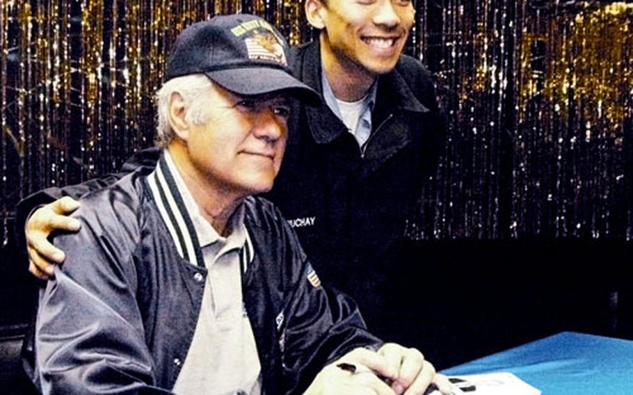 Jeopardy! game show host Alex Trebek donned the hat of USS Kitty Hawk Petty Officer 2nd Class Errol Dychiuchay Thursday when the show stopped at Yokosuka Naval Base. Trebek and Jeopardy representatives are visiting bases in Japan and Okinawa this week to scout contestants and show support for the troops.