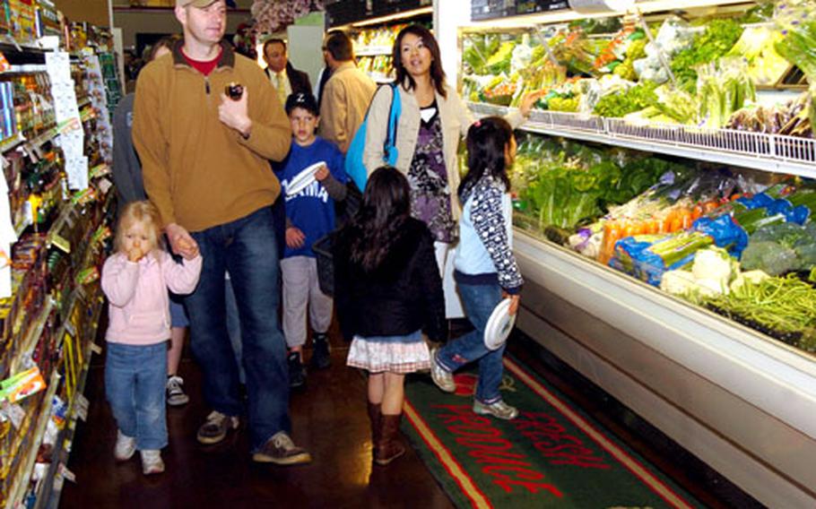 Shoppers check out the new commissary Saturday at Camp Zama.