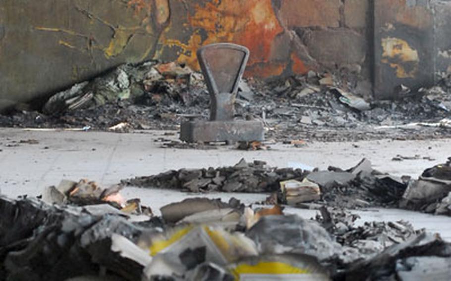 A scorched scale stands amid the ashes of torched snack boxes and factory walls at the former Alriyadhi Potato Snack Factory in New Baghdad. The factory has since been converted into a combat outpost and commanders say the new position will help in the revitalization of the once-booming industrial area.