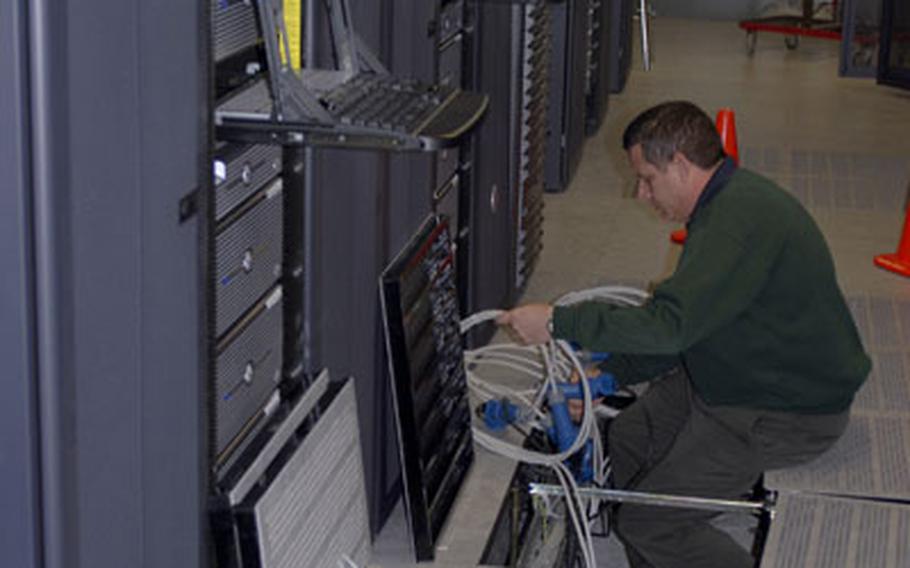 Grafenwöhr Area Processing Center chief Bill Kunz works on one of 150 servers at the new facility on Monday.