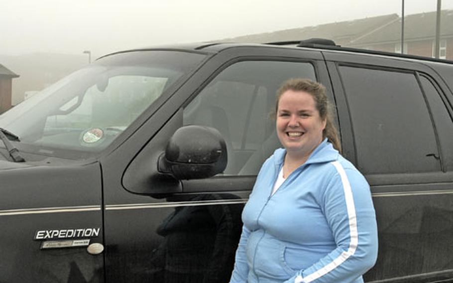 Shirley McCarter stands next to her Ford Expedition.