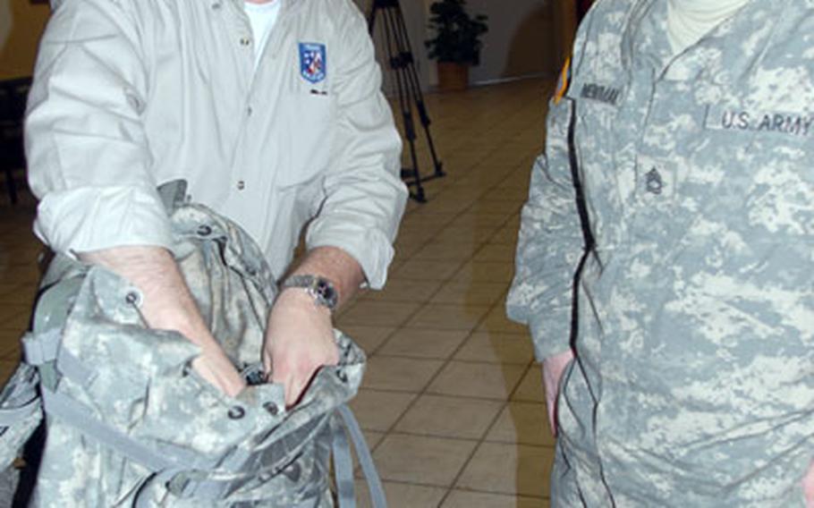 Executive Office Soldier representative Ronald Krakulis, left, shows a new backpack to 2nd Cavalry (Stryker) Regiment soldier Sgt. 1st Class Charles Newman, 29, of Gulfport, Miss.