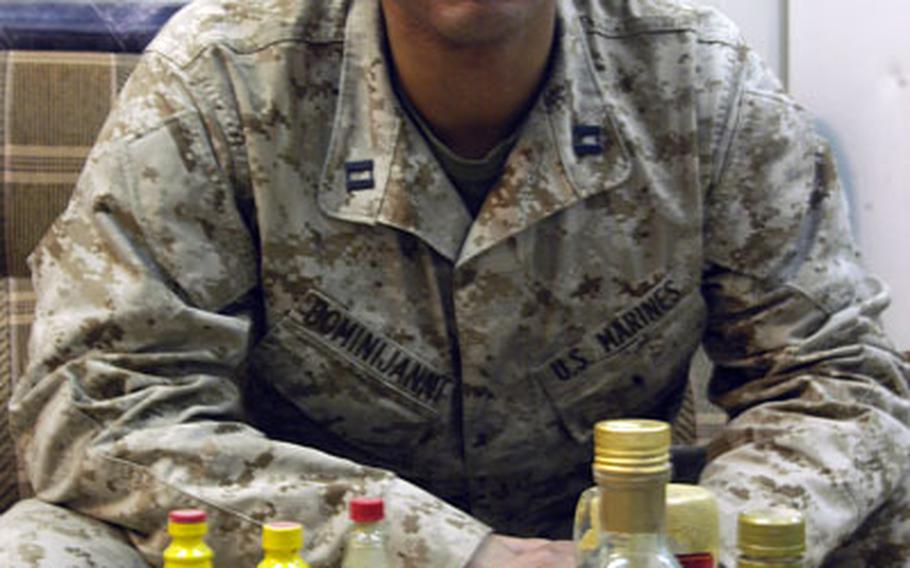Marine Capt. Eric Dominijanni, 34, keeps a supply of sauces, spices and spreads that he says helps him stomach the food served at the chow hall food at Camp Fallujah, Iraq. As a culinary specialist, the grub doesn't always quite suit his palette. Dominijanni, the commanding officer of Company B, Assault Amphibious Battalion, now in Iraq, beat famed TV personality Bobby Flay in a televised contest last summer.