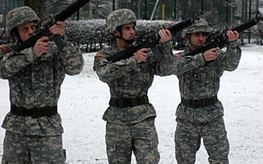 Members of an Army honor guard in Giessen, Germany, participate in a 21-gun salute Thursday for Spc. Alan E. McPeek, of Company A, 16th Engineer Battalion, 1st Brigade Combat Team, 1st Armored Division. McPeek died a week ago Friday during his final mission in Iraq.
