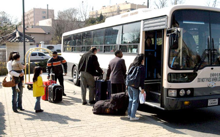 Passengers bound for Incheon International Airport board the airport shuttle bus at the Dragon Hill Lodge.