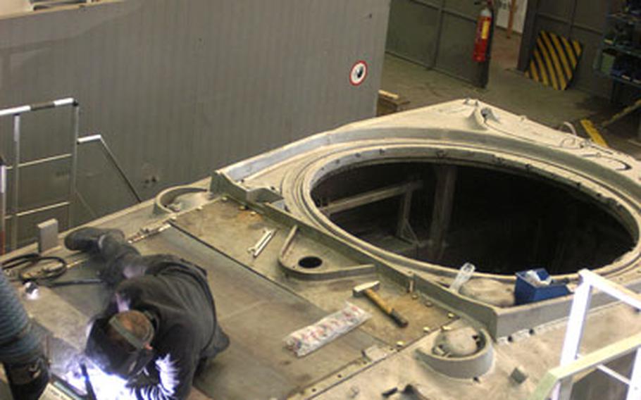 For the past few months, a Belgian army unit in Liege, Belgium, has been renovating a World War II Sherman tank normally on display in Bastogne. With the project nearly complete, Belgian civilian Laurent Pironnet does some welding work on the hull in preparation for the paint shop. The tank is expected to be back in McAuliffe Square in time for the Memorial Day weekend next month.