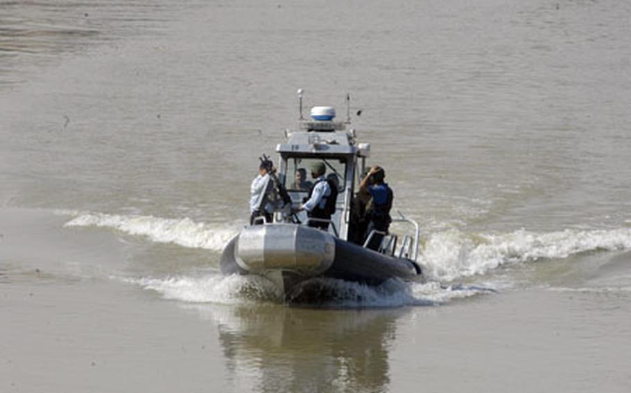 Iraqi policemen who make up the Baghdad River Patrol Station unit patrol the Tigris River in Baghdad. The unit monitors more than 35 miles of waterways in and around the Baghdad area.