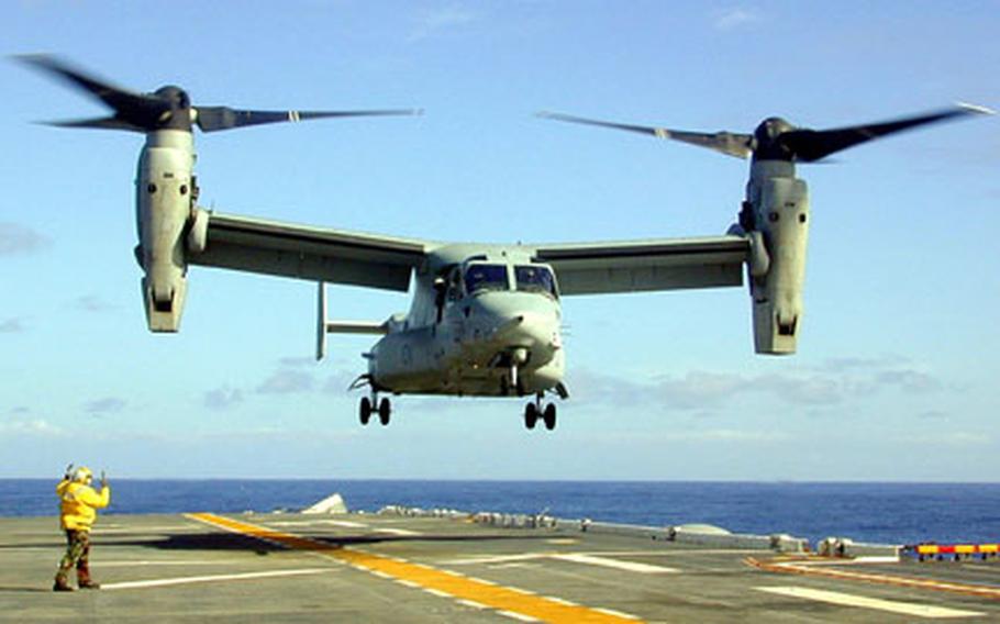 Aviation Boatswain's Mate Handler 3rd Class Jerry Lowe of Demopolis, AL directs an MV-22 "Osprey" in for landing on the flight deck of the landing helicopter dock ship USS Essex (LHD 2). Essex is operating off the coast of Southern California conducting operational testing of the MV-22 "Osprey".